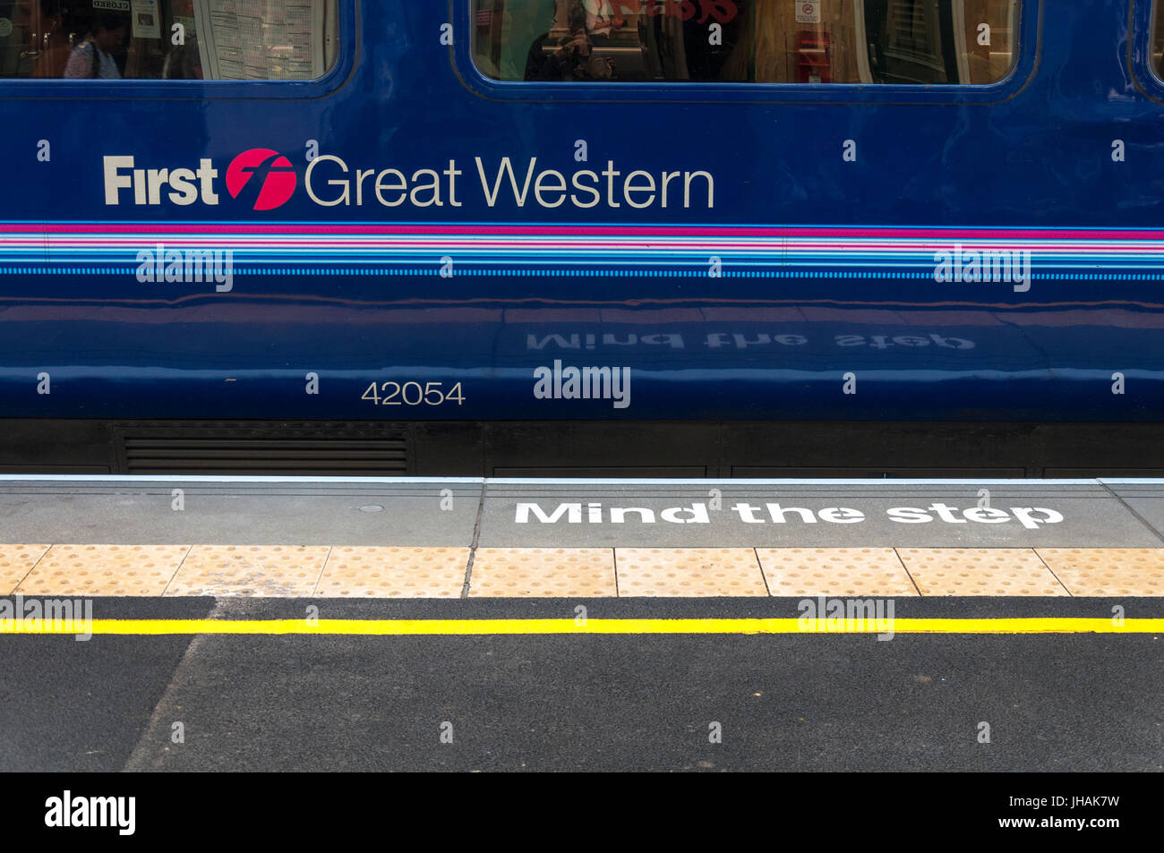 Mind the Step safety warning and a First Great Western train at Bath Spa railway station, Somerset, England, UK Stock Photo