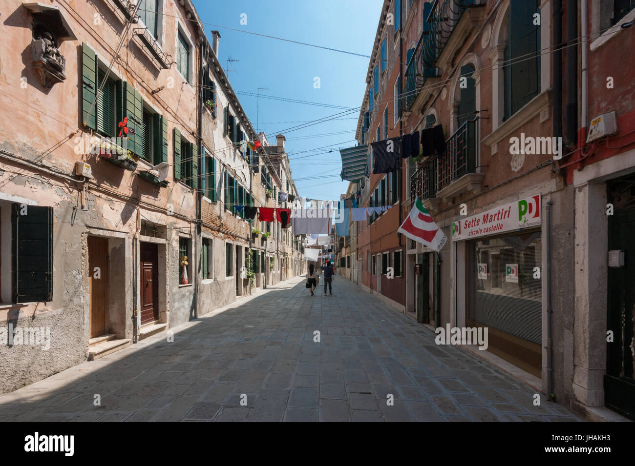 The real Venice  - a street in the sestiere Castello area of Venice with houses, washing lines, hanging clothes and a PD party club Stock Photo
