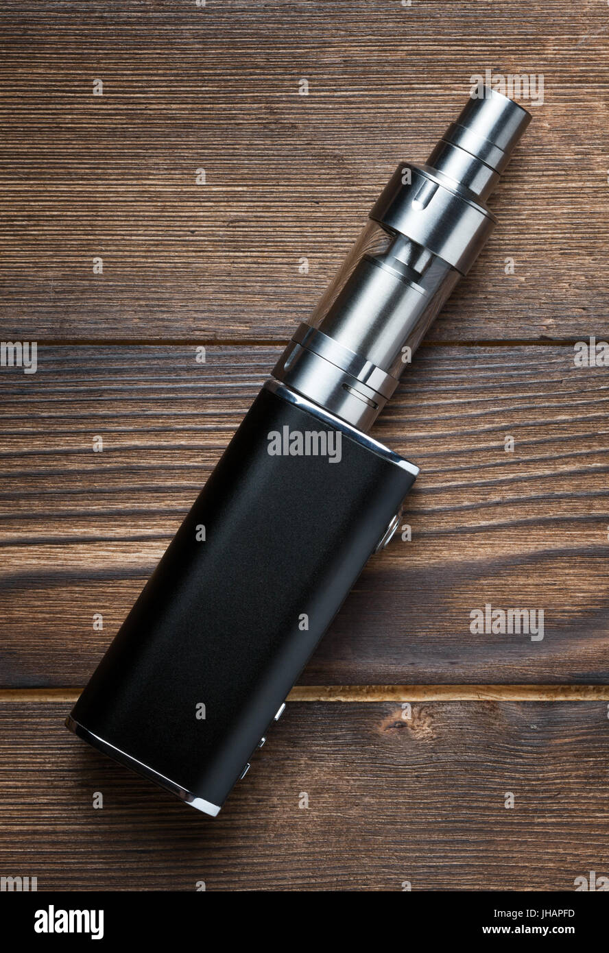 electronic cigarette on brown wooden background Stock Photo - Alamy