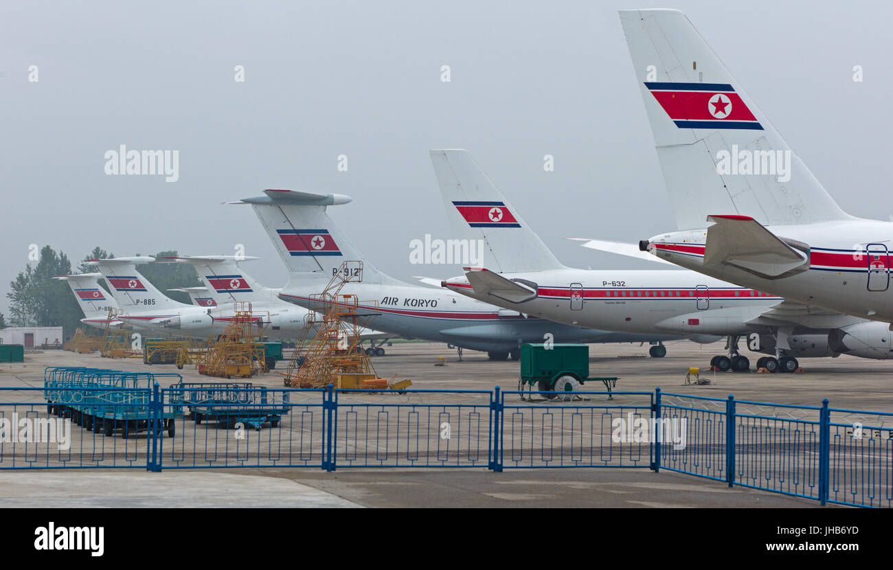 Tailplanes and rear fuselages of Russian Tupolev and Ilyushin aircraft of Air Koryo parked at Pyongyang Sunan International Airport. DPRK / North Kore Stock Photo