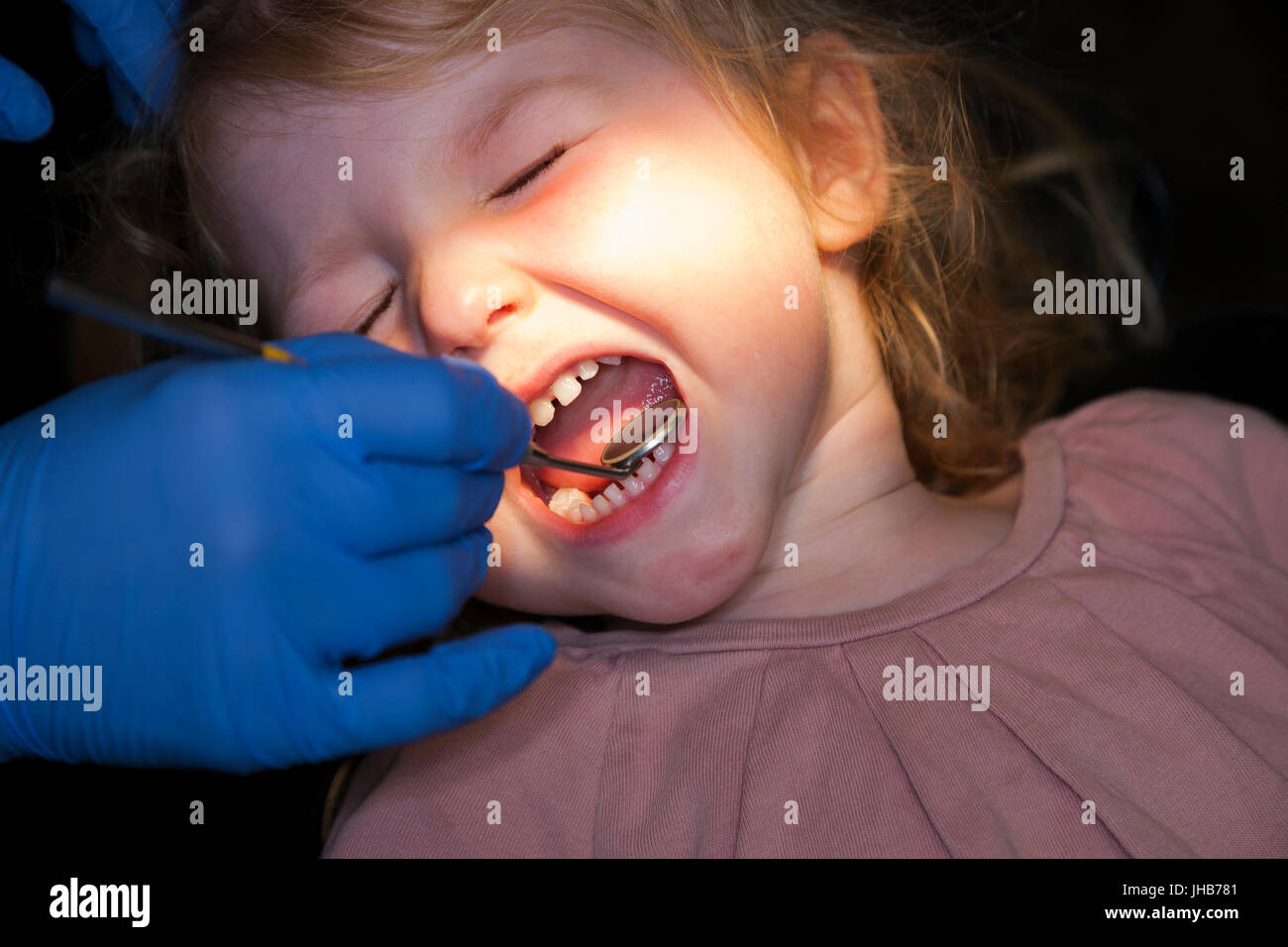 Toddler girl / 2 or 3  yr / two or three year old child during check up with childrens dentist / children's dental practice. UK Stock Photo