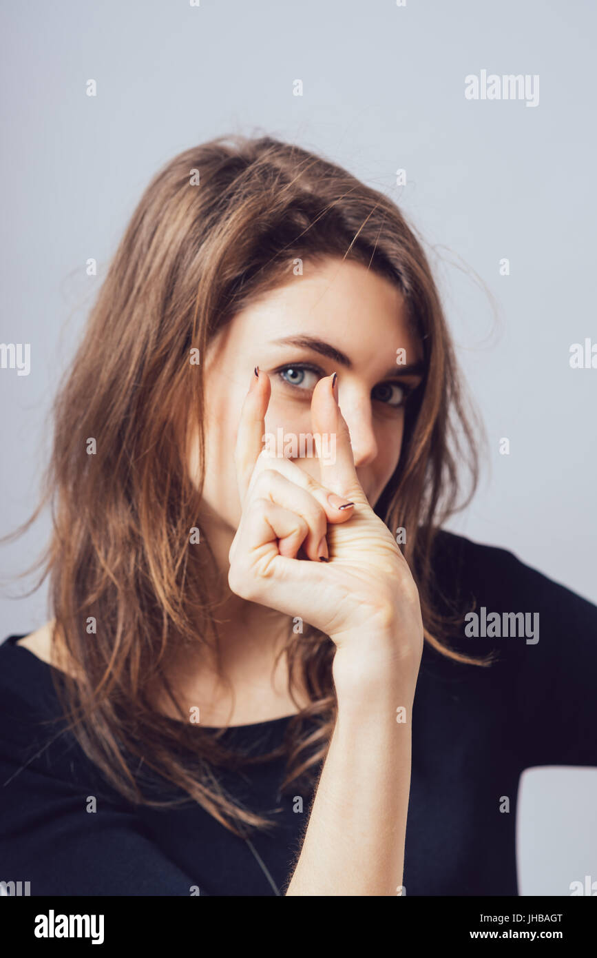 Beautiful woman shows small size Stock Photo - Alamy