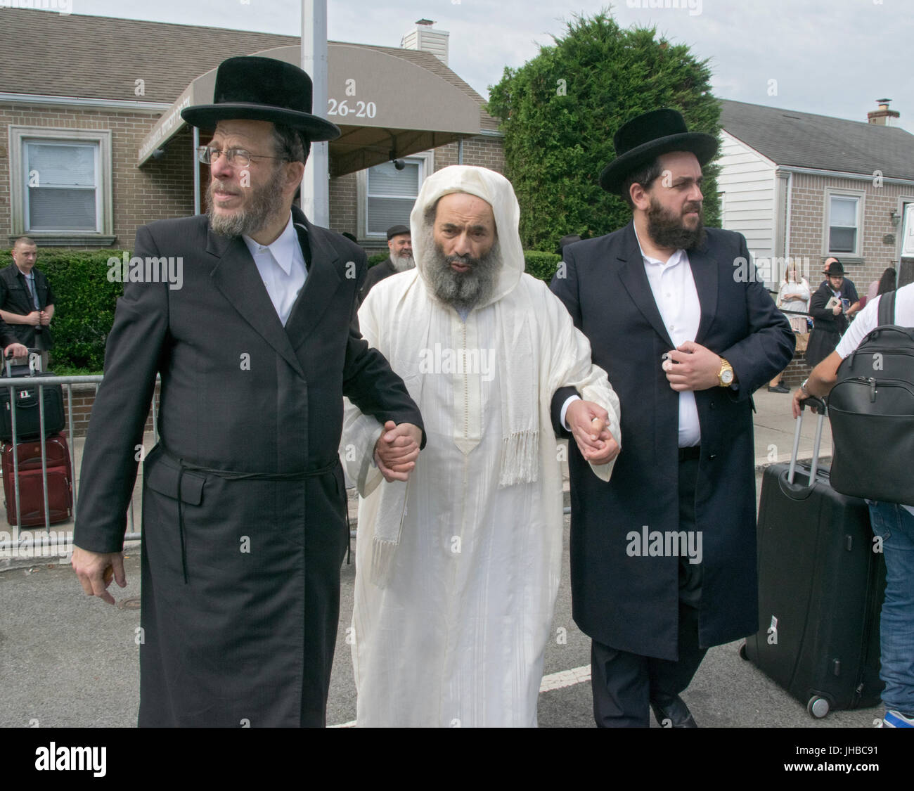 A Moroccan Rabbi (c) and Kabbalah scholar is led from a synagogue to an ...