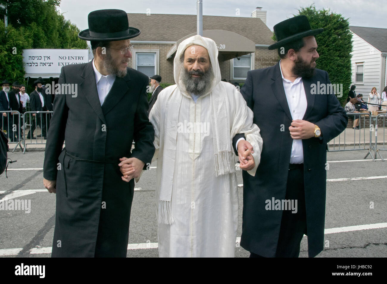 A Moroccan Rabbi (c) and Kabbalah scholar is led from a synagogue to an ...