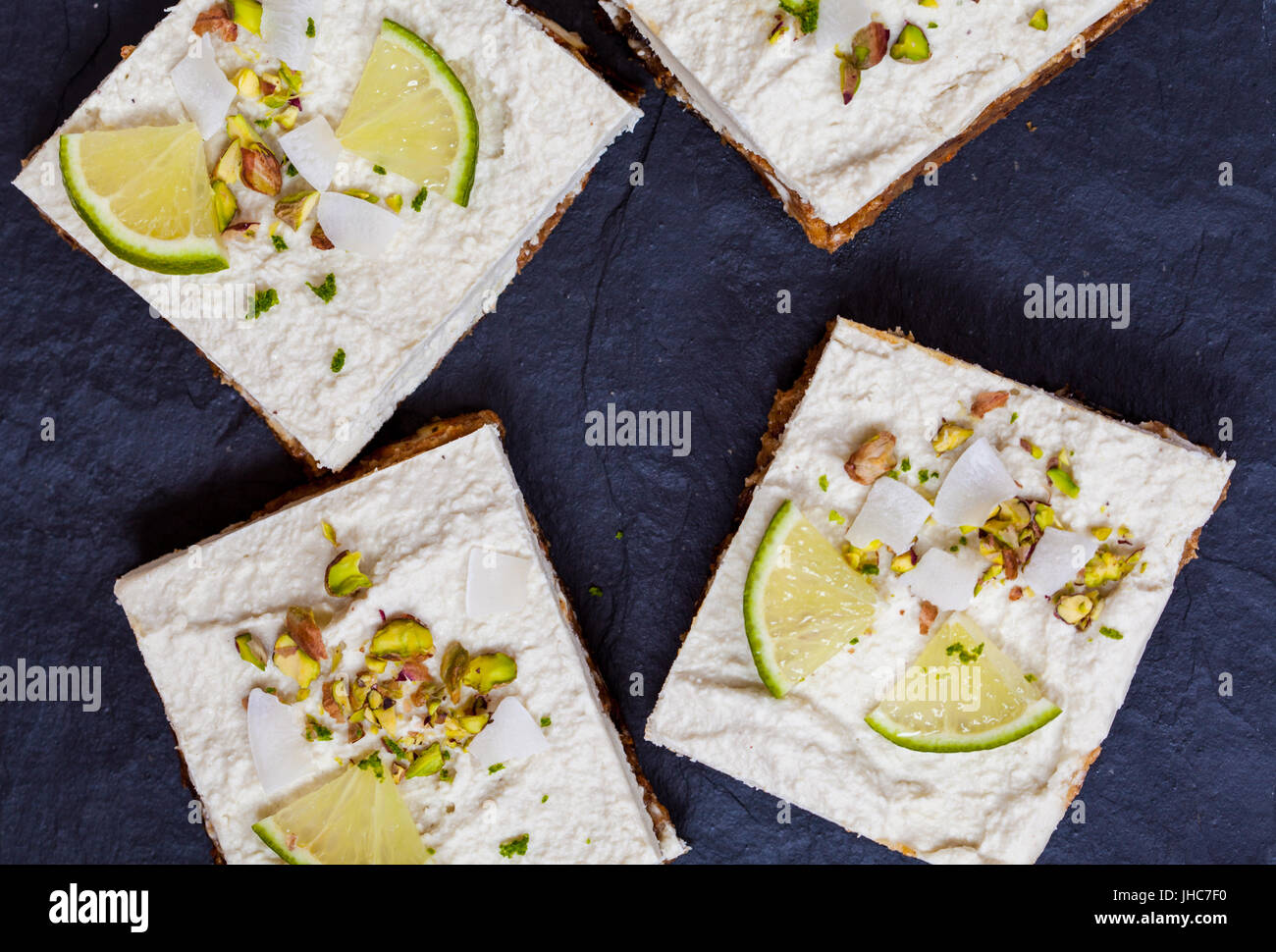 Raw pistachio, coconut and lime cheesecakes. Love for a healthy vegan food concept. Stock Photo