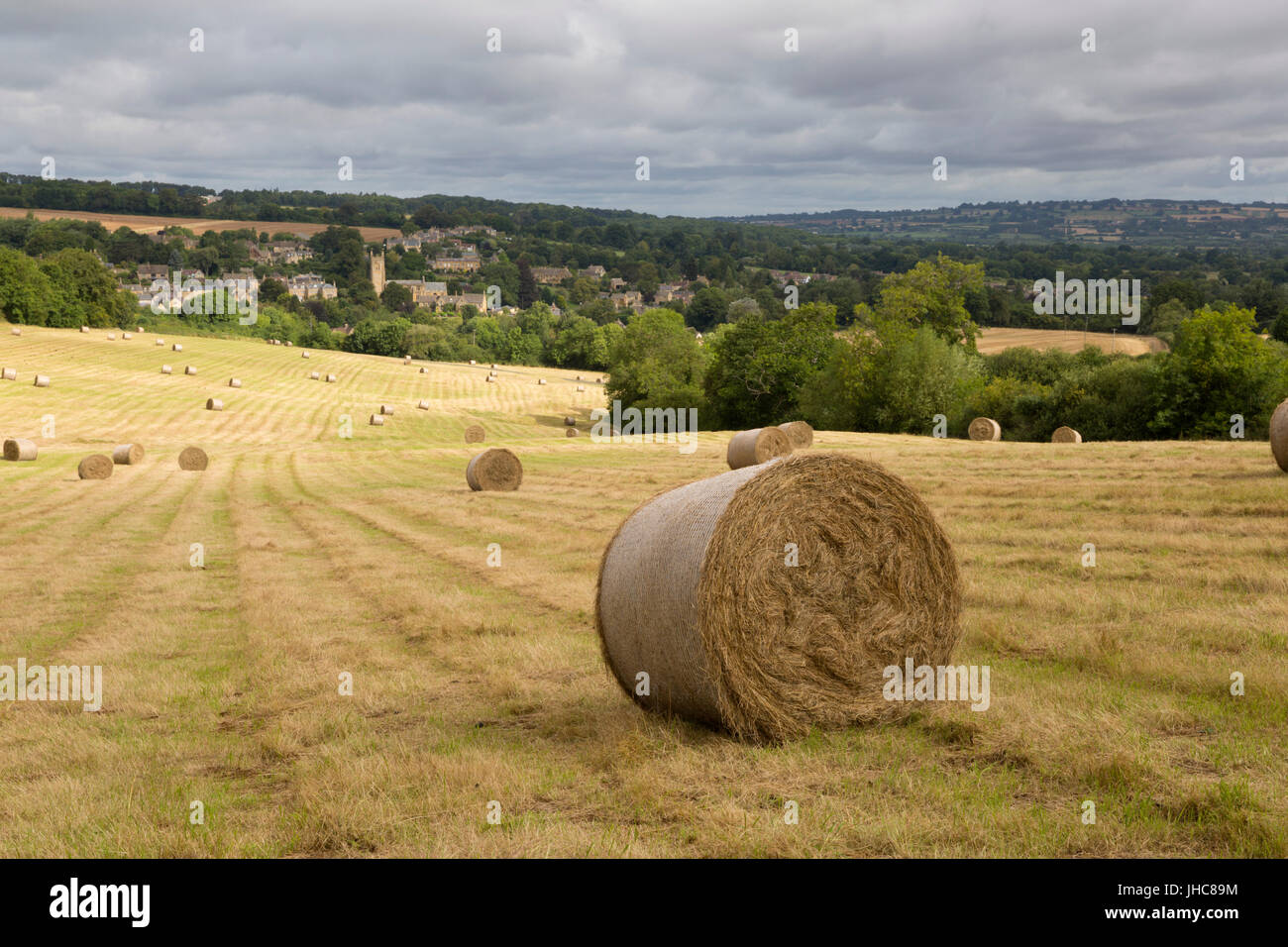 View over Cotswold village of Blockley with round hay bales, Blockley, Cotswolds, Gloucestershire, England, United Kingdom, Europe Stock Photo