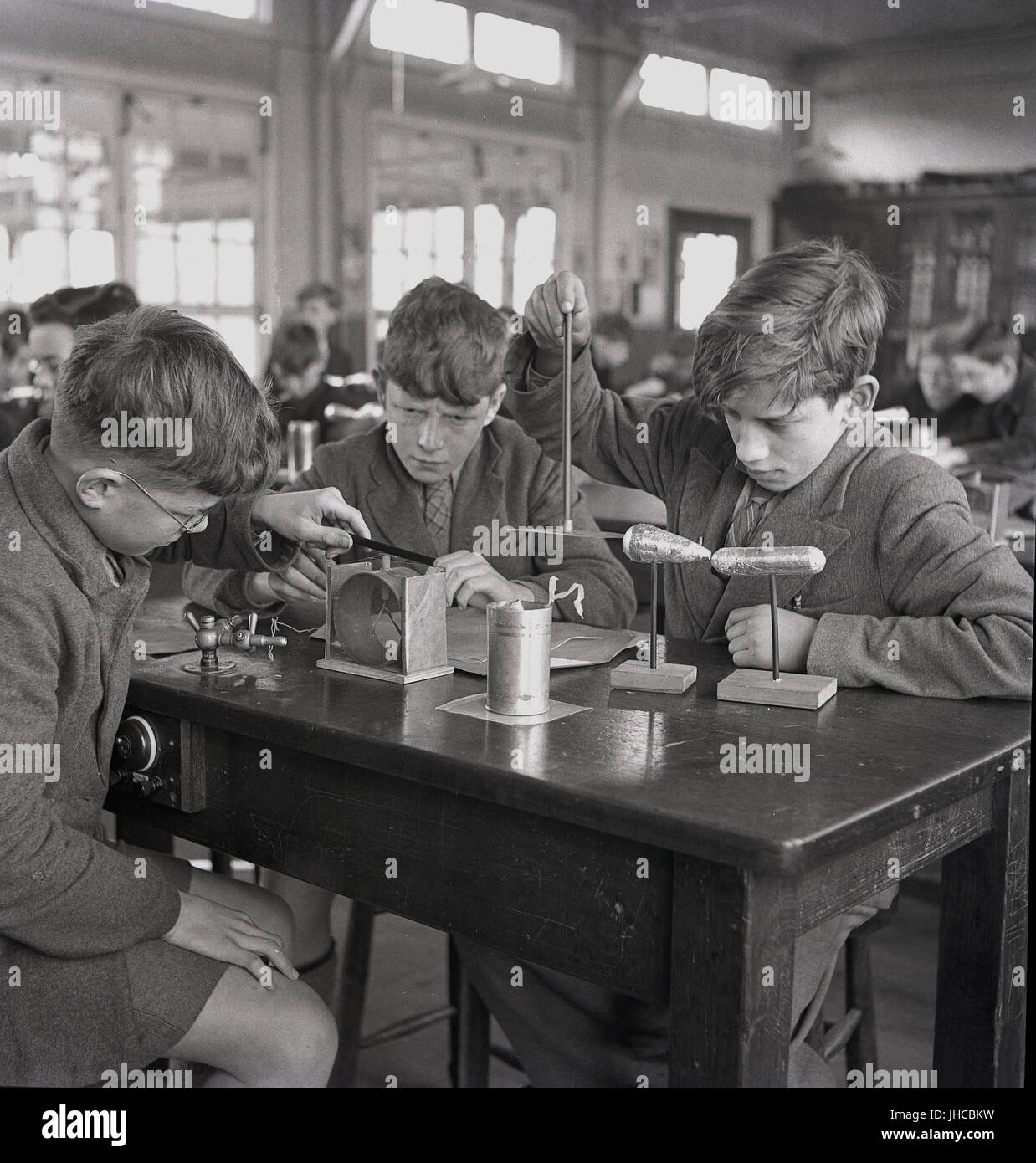 1950s, historical, three boys at the Sidcup secondary modern school, a British state school, experimenting with different scale models in a science lesson. Stock Photo