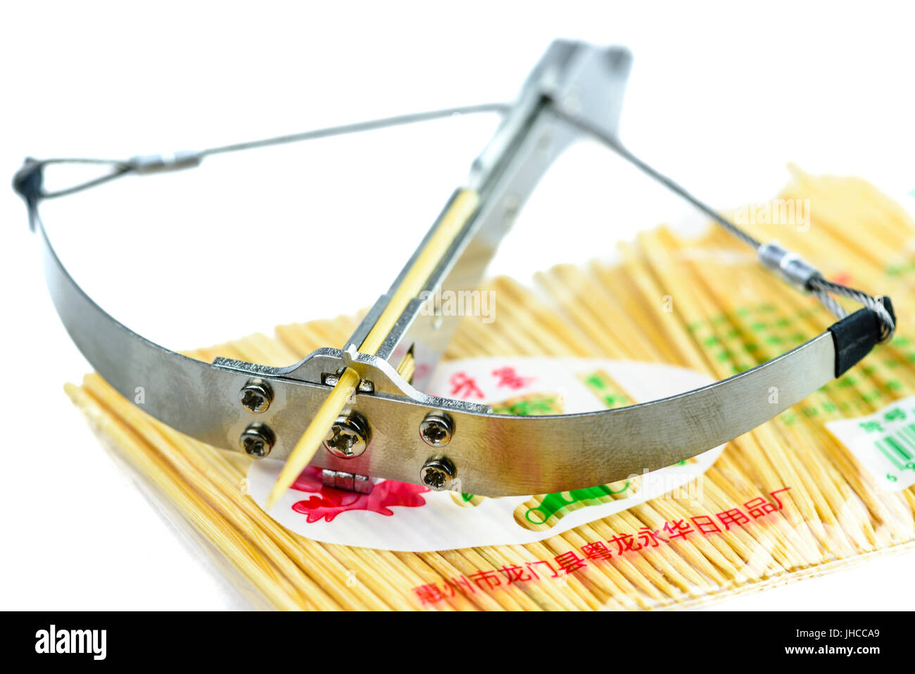 Toothpick catapult, a dangerous steel 'toy' from China which fires toothpicks with enough force to break skin and embed the projectile in an apple. Stock Photo