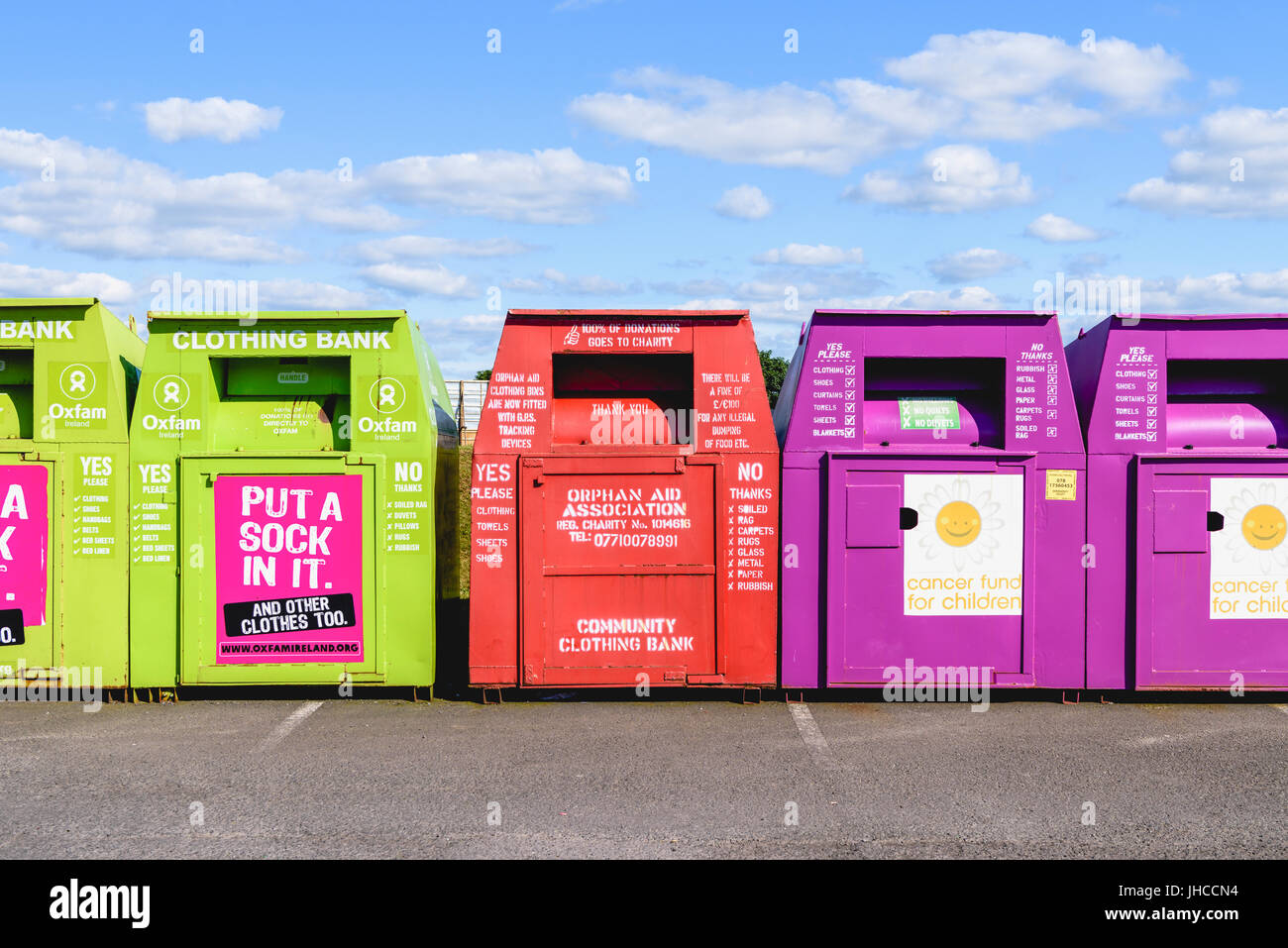 Clothes recycling bins at a car park. Stock Photo