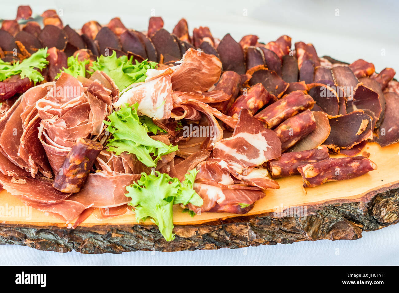 Sausage slices on board Stock Photo Alamy