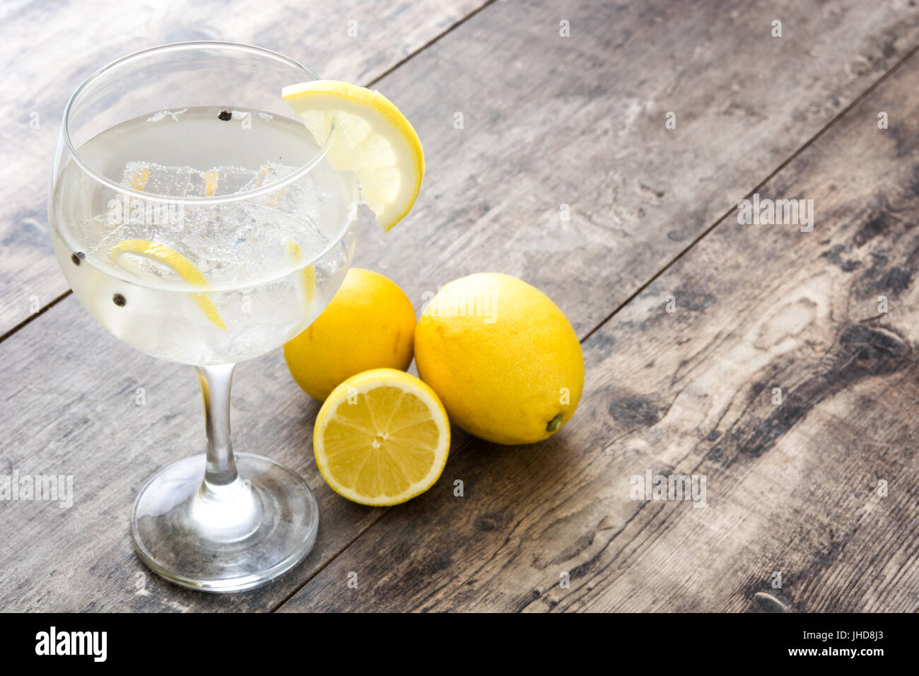 Glass of gin tonic with lemon on wooden background Stock Photo Alamy