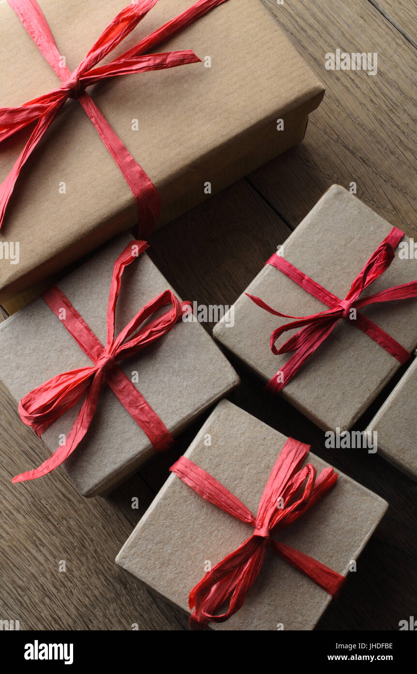 Black gift box wrapped with a red and tan natural raffia bow on a white  background. Horizontal shot. Isolated on white Stock Photo - Alamy