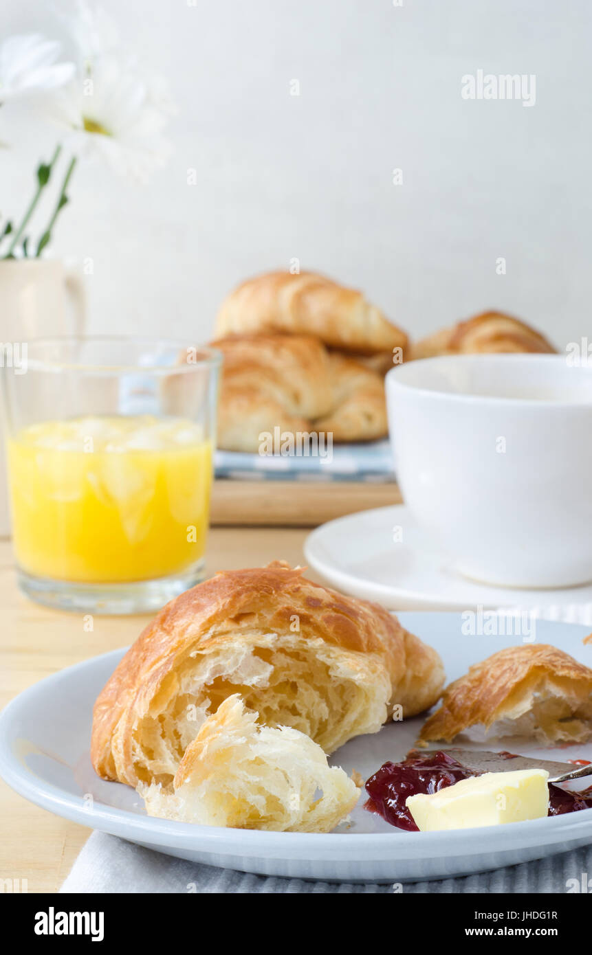 Continental Breakfast table setting laid with croissants, orange juice