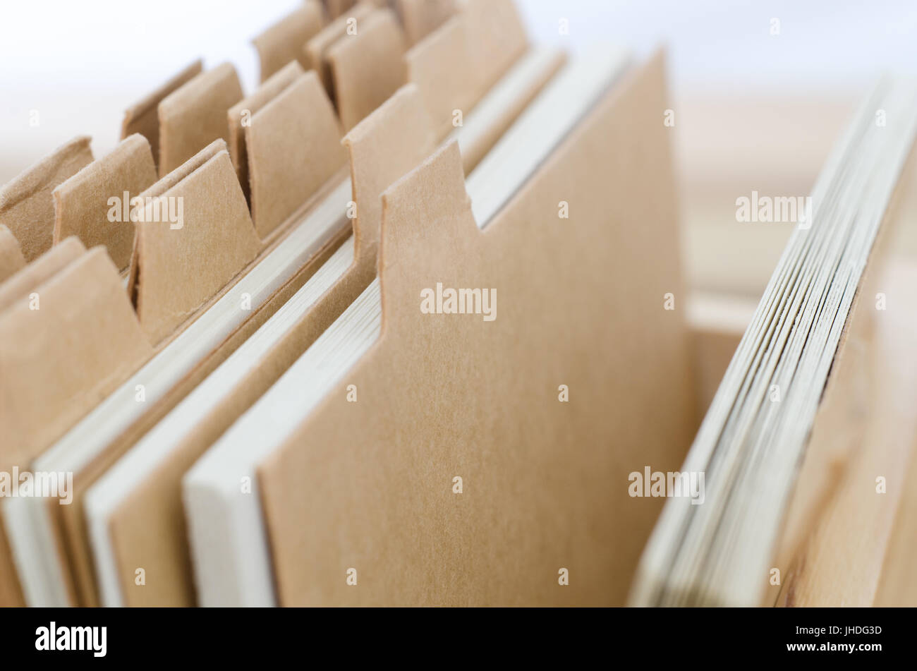 Close up of index cards with plain light brown dividers left blank to provide copy space. Elevated and angled side view. Stock Photo