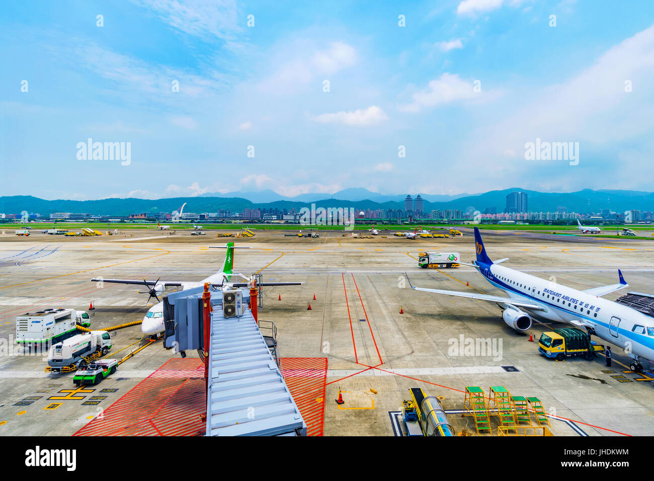 TAIPEI, TAIWAN - JUNE 09: This is a view of the runway of Songshan airport with airplanes getting ready to board passengers on June 09, 2017 in Taipei Stock Photo