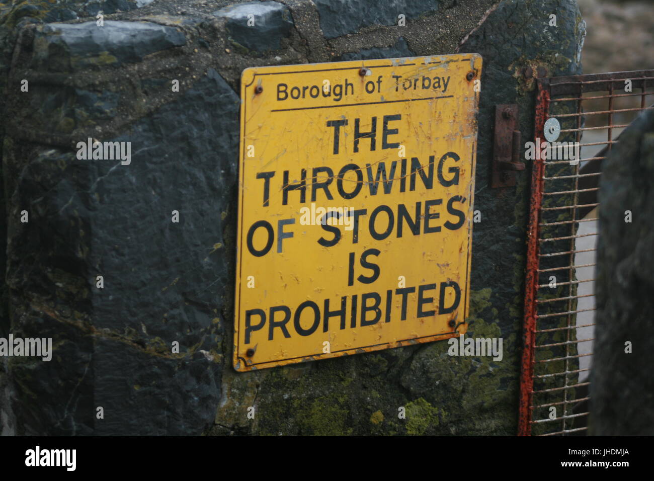those in glass houses should not throw stones,sign,warning sign,throwing stones,prohibited,stone throwing, throwing stones, beach signs, signage, Stock Photo