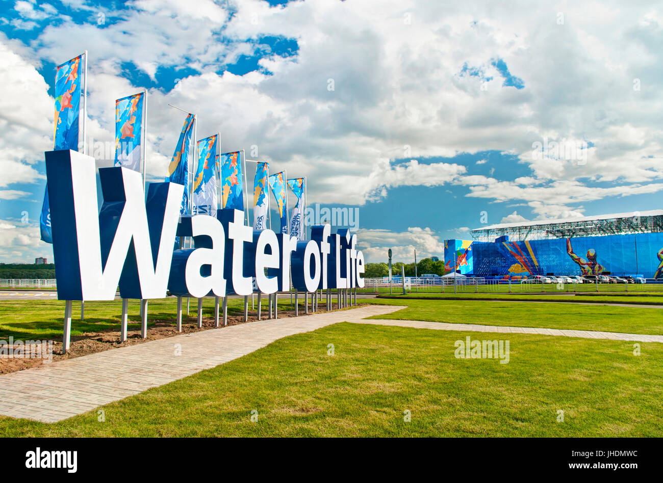 KAZAN, RUSSIA - 25 July 2015: 16th FINA World Championships 2015 slogan Water of Life and flags at Fina Water World Park entrance against blue sky and Stock Photo