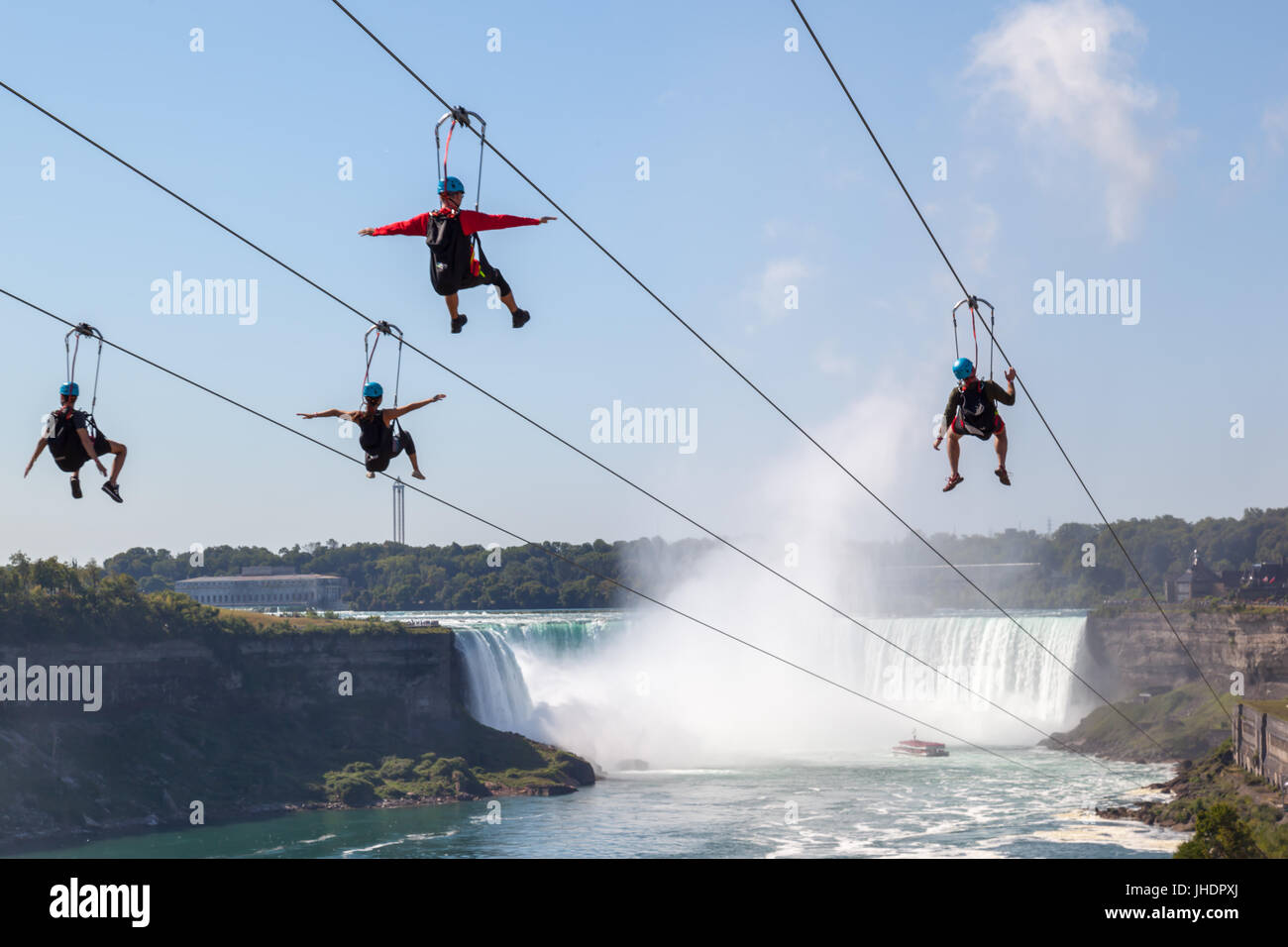 unrecognizable people taking zipline ride at Niagara Falls on Sep. 4, 2016, Ontario. New zipline in Niagara Parks opened in the summer of 2016 Stock Photo