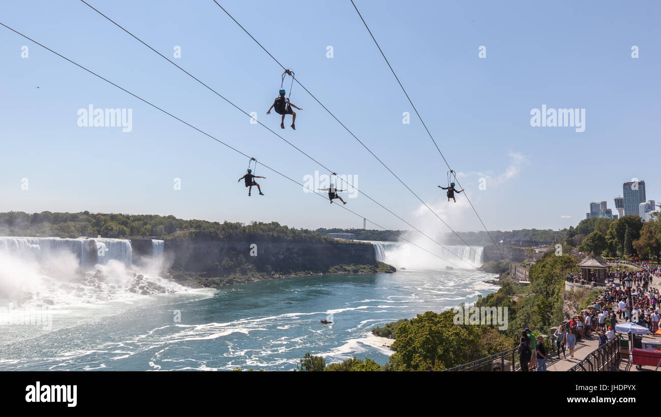 unrecognizable people taking zipline ride at Niagara Falls on Sep. 4, 2016, Ontario. New zipline in Niagara Parks opened in the summer of 2016 Stock Photo
