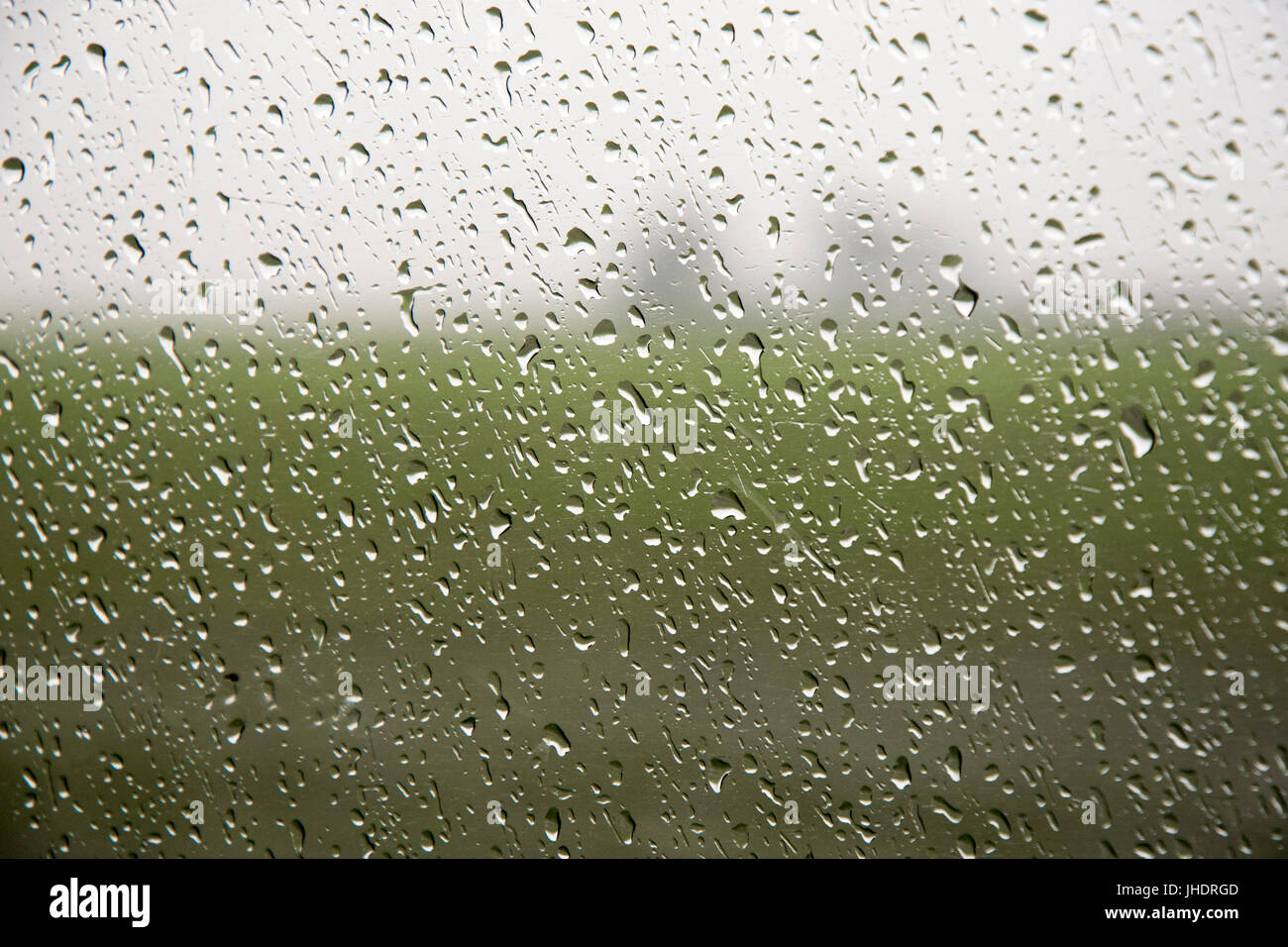 Raindrops seem frozen on windows of the fast moving Amtrak train Southwest Chief, in western Illinois. Stock Photo