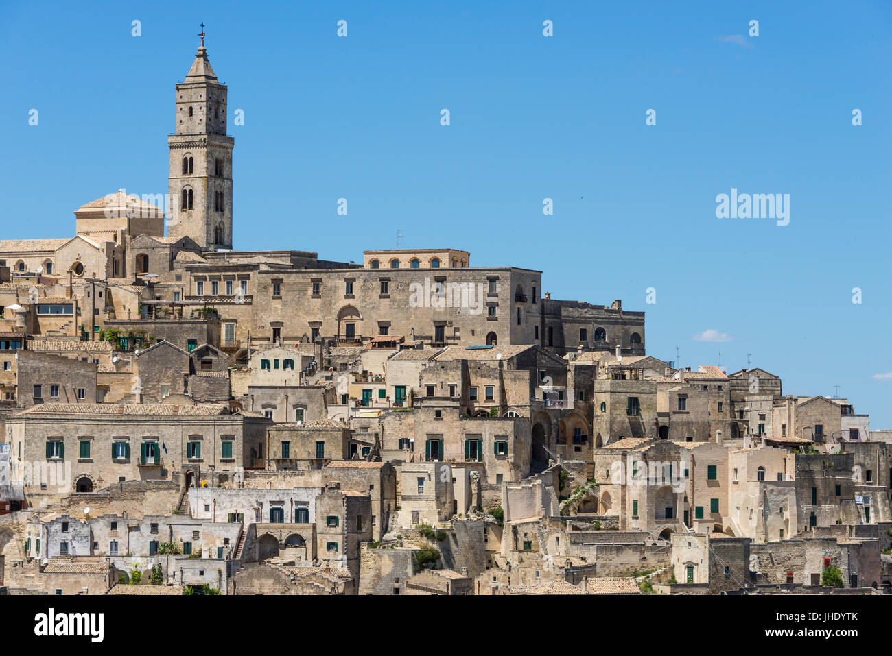 Old houses and a church in ancient architecture in the same kind of stone in a town built upon a hill, known as the Sassi di Matera in Basilicata, Ita Stock Photo