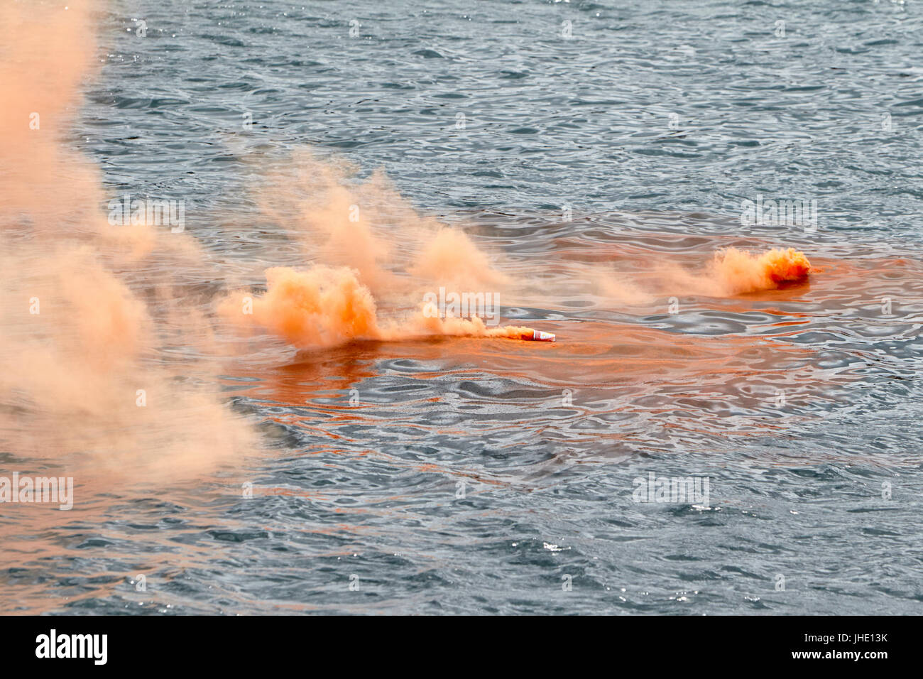 orange floating signal flares emergency smoke Stock Photo