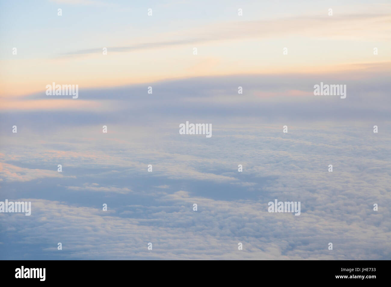 flying above the clouds at sunset landscape from an airplane Stock ...
