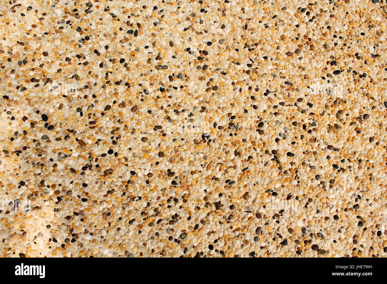 Concrete base with pebbles embedded known as Pebblecrete. Stock Photo