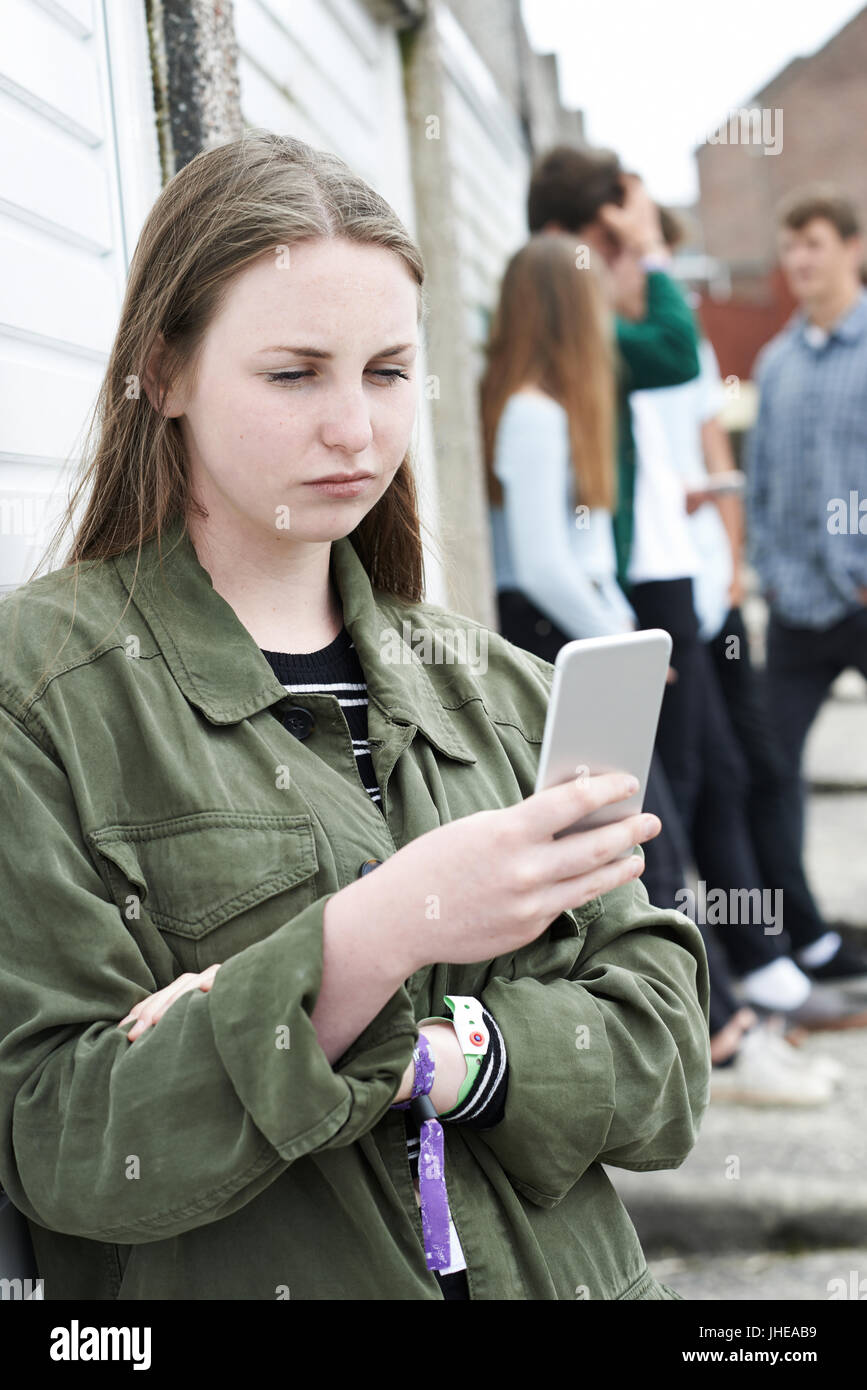 Teenage Girl Using Mobile Phone In Urban Setting Stock Photo