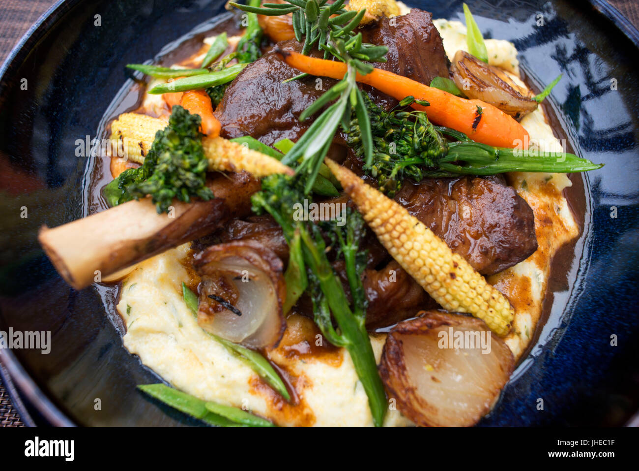 Delicious Wild Rosemary Lamb Shank dish in the Camissa Brasserie Restaurant, Victoria and Alfred Waterfront, Cape Town, Western Cape, South Africa Stock Photo