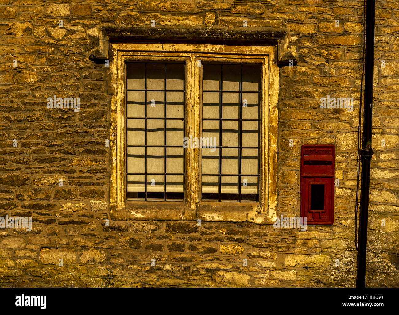 Old wooden window in a historic building, characteristic stone facade ...