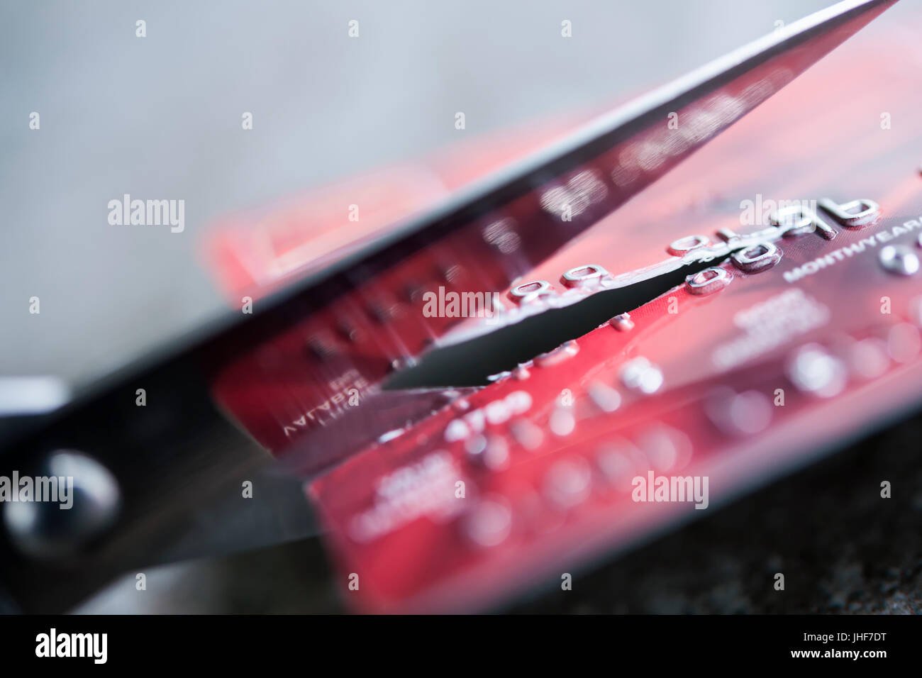 Credit card being cut with scissors, close up. Stock Photo