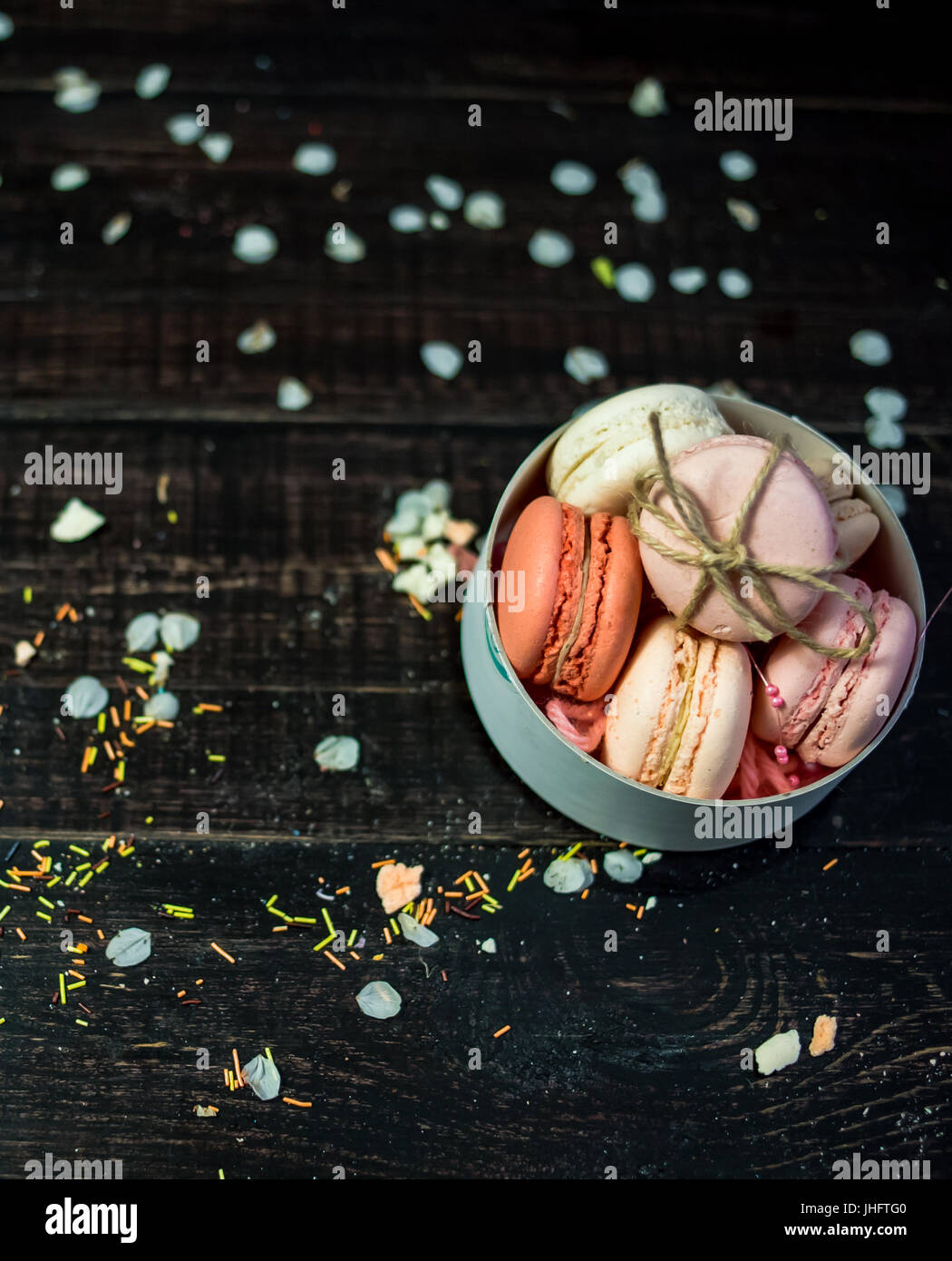 Multi color pastel macaroons in white deep plate decorated with rope ...