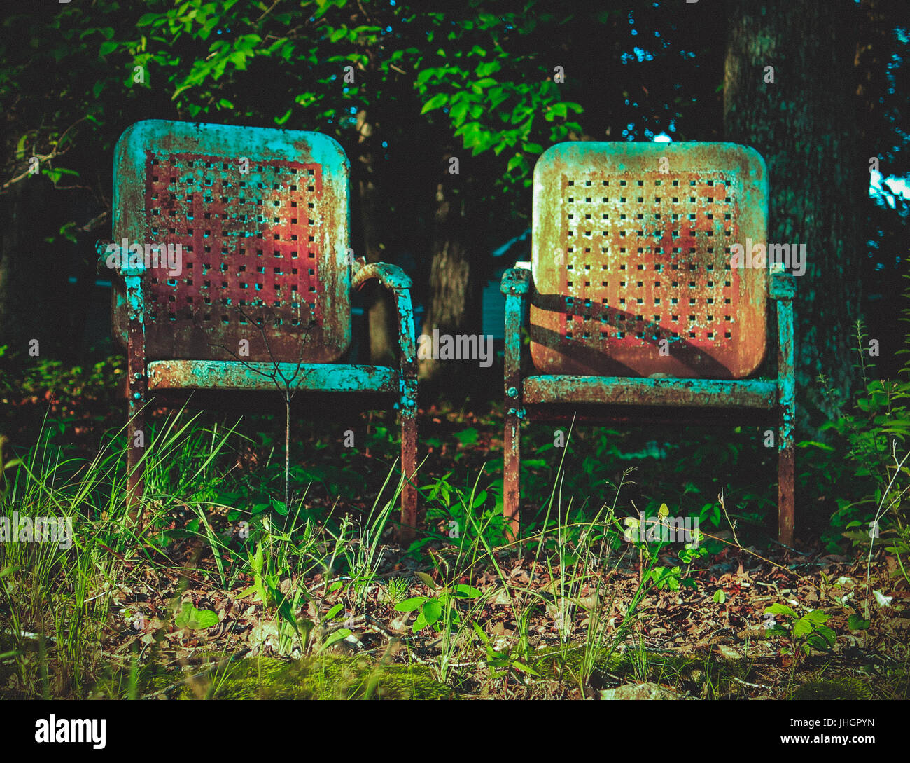 Old chairs looking out on a lake. Stock Photo