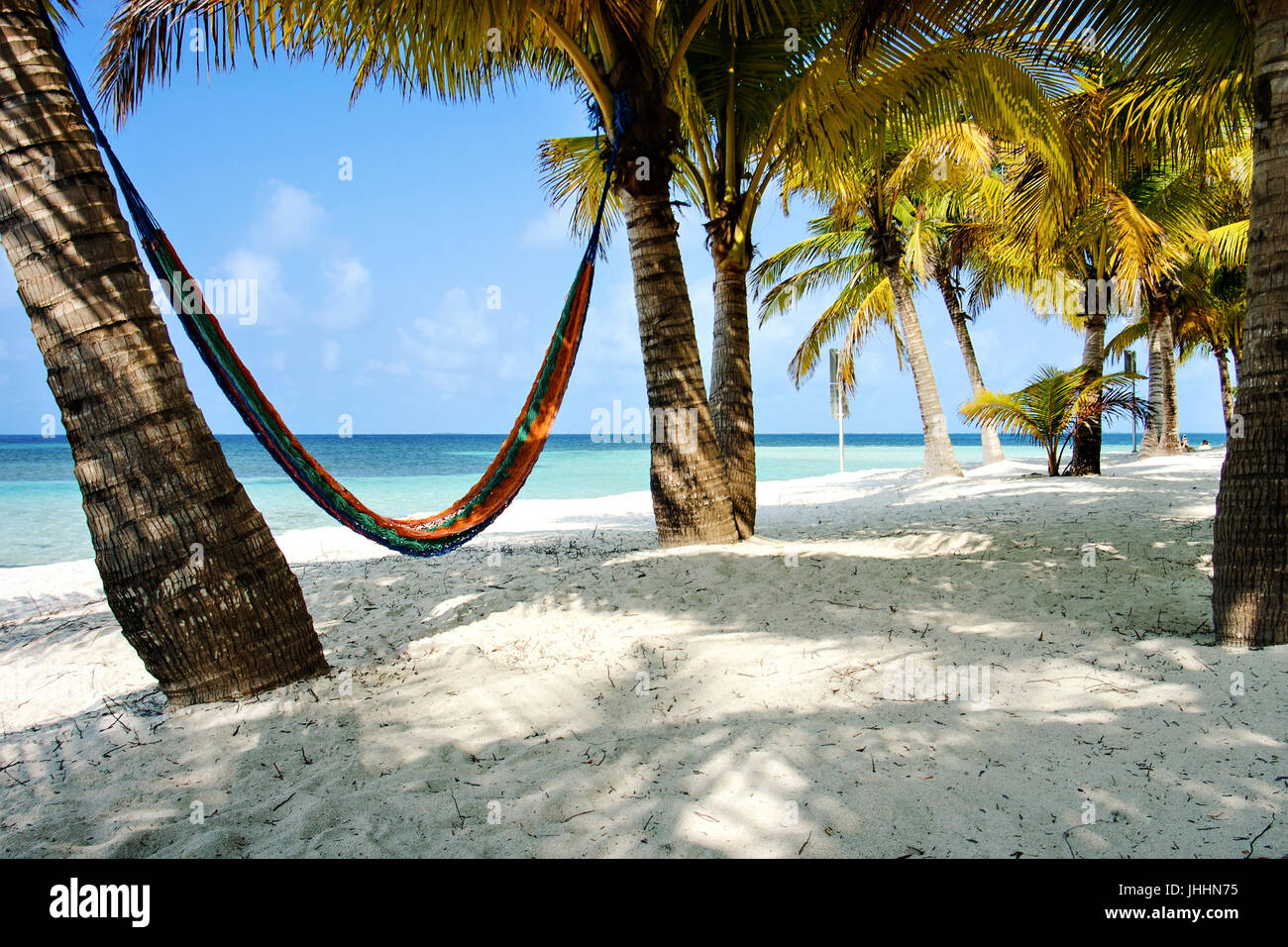 South Water Caye, Belize. Beach with a hammock and ocean view. Stock Photo