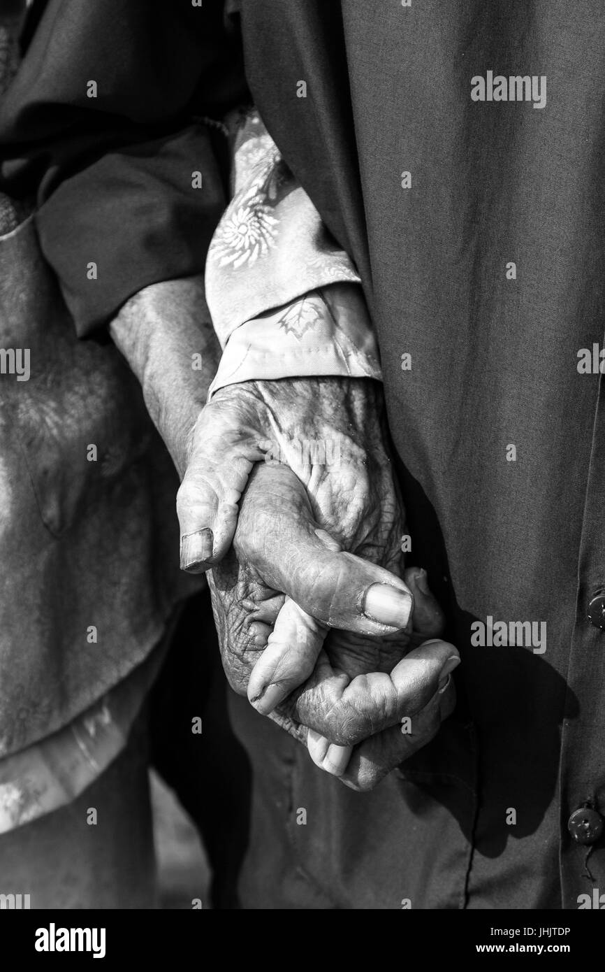 Black and white of everlasting love - old couple holding hands Stock Photo