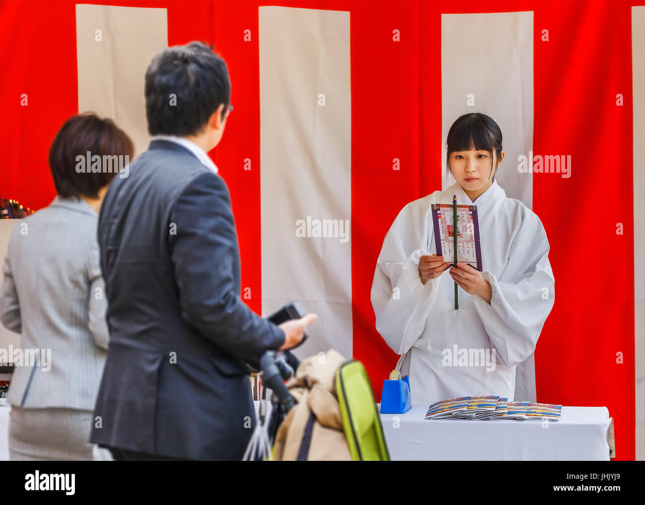 KOBE, JAPAN - NOVEMBER 17: Miko at Ikuta-jinja in Kobe, Japan on November 17, 2013. 'Miko' is an institutionalized in daily shrine life, trained to pe Stock Photo