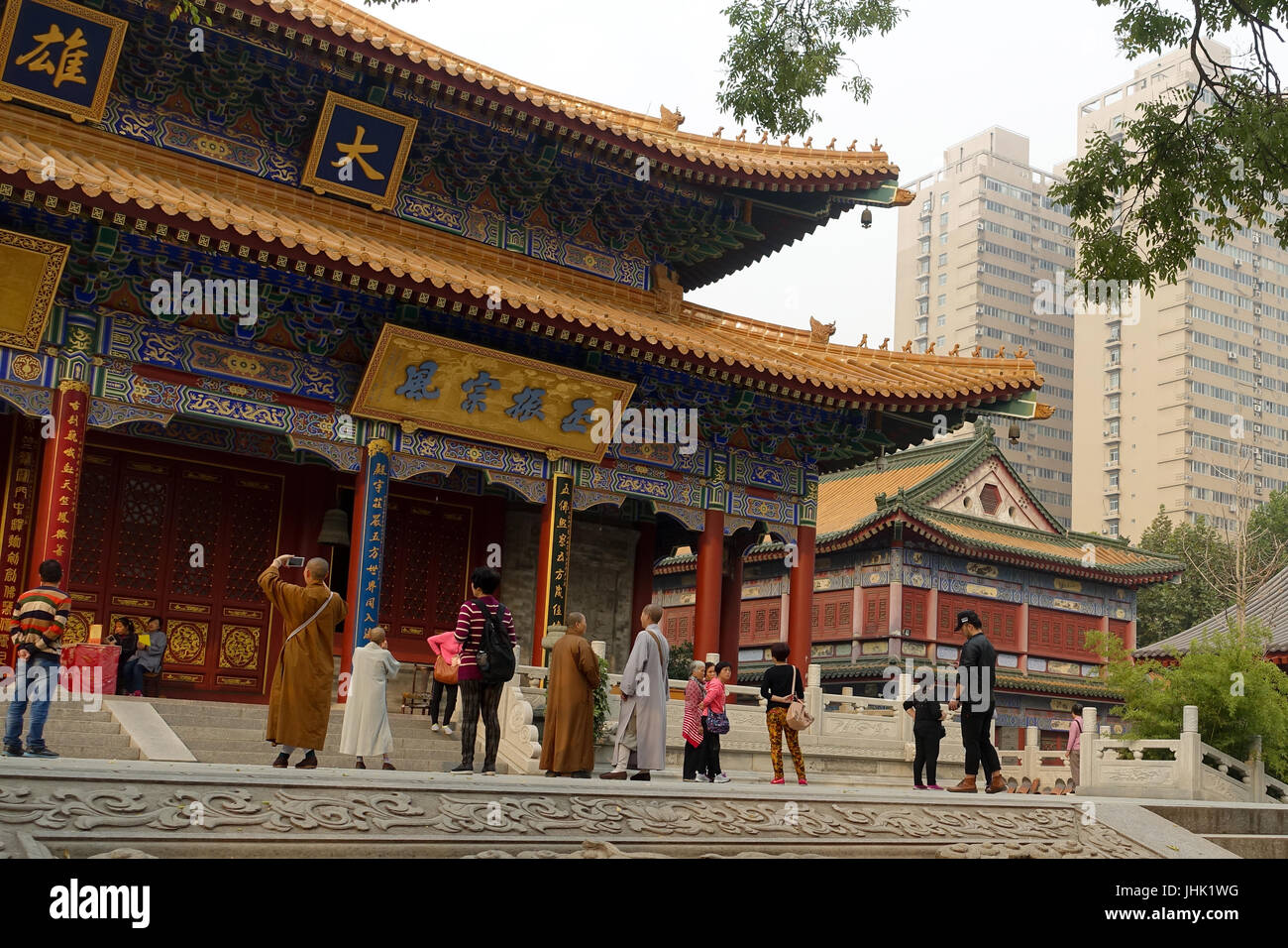 Xi'an, China - 2015, 18 October: Monks photographing inner city budhist temple. Stock Photo