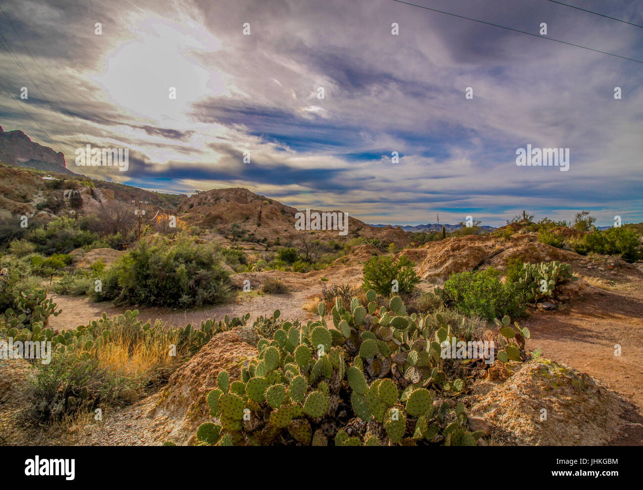 Arizona Landscape with Sun Peeking Through Clouds Stock Photo