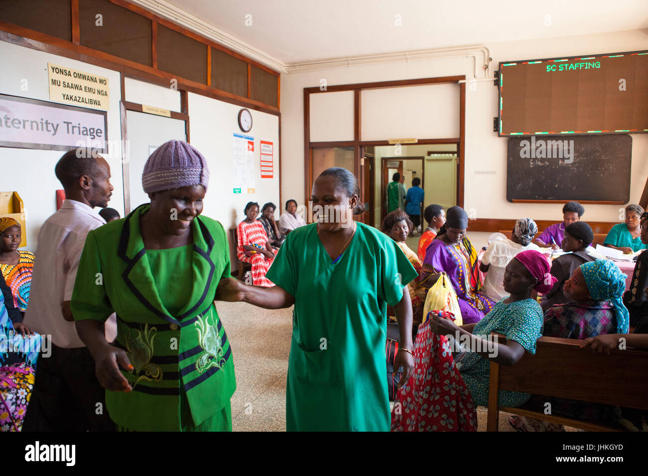 A ward sister helps ladies whist they wait at Mulago Hospital, Uganda. Stock Photo