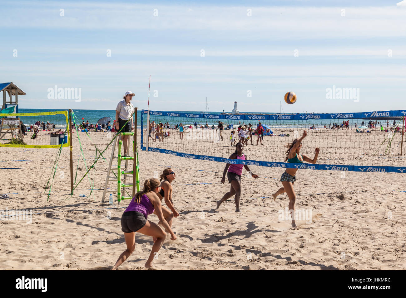 Four women playing beach volleyball during competition held on Victoria Beach in Cobourg, Ontario. Stock Photo