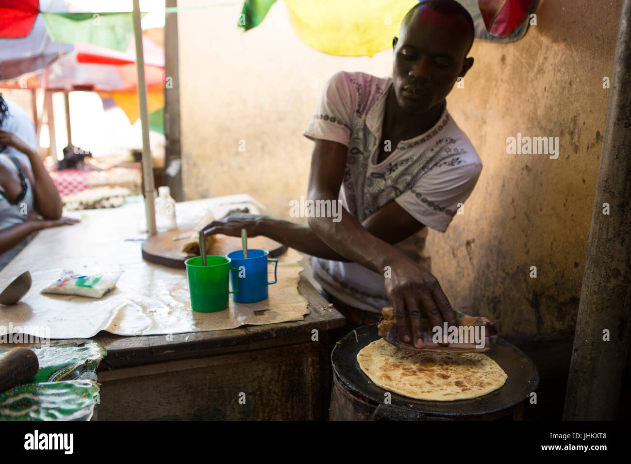 A Uganda Rolex being made by the side of the road. A rolex is a ...