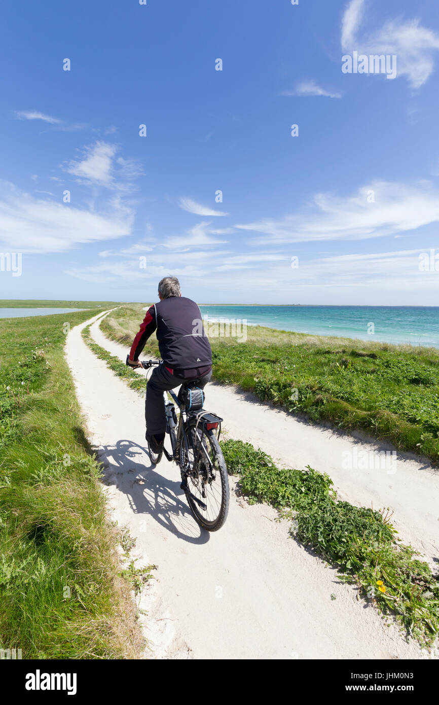 Cycling on Isle of Sanday, Orkney Isles Stock Photo