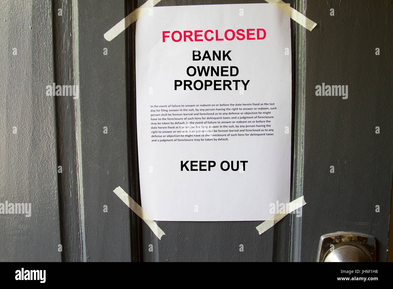 Foreclosed property notice taped on a house door property Stock Photo