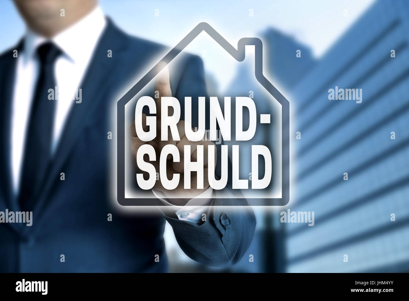 Grundschuld (in german Mortgage) touchscreen is operated by businessman. Stock Photo