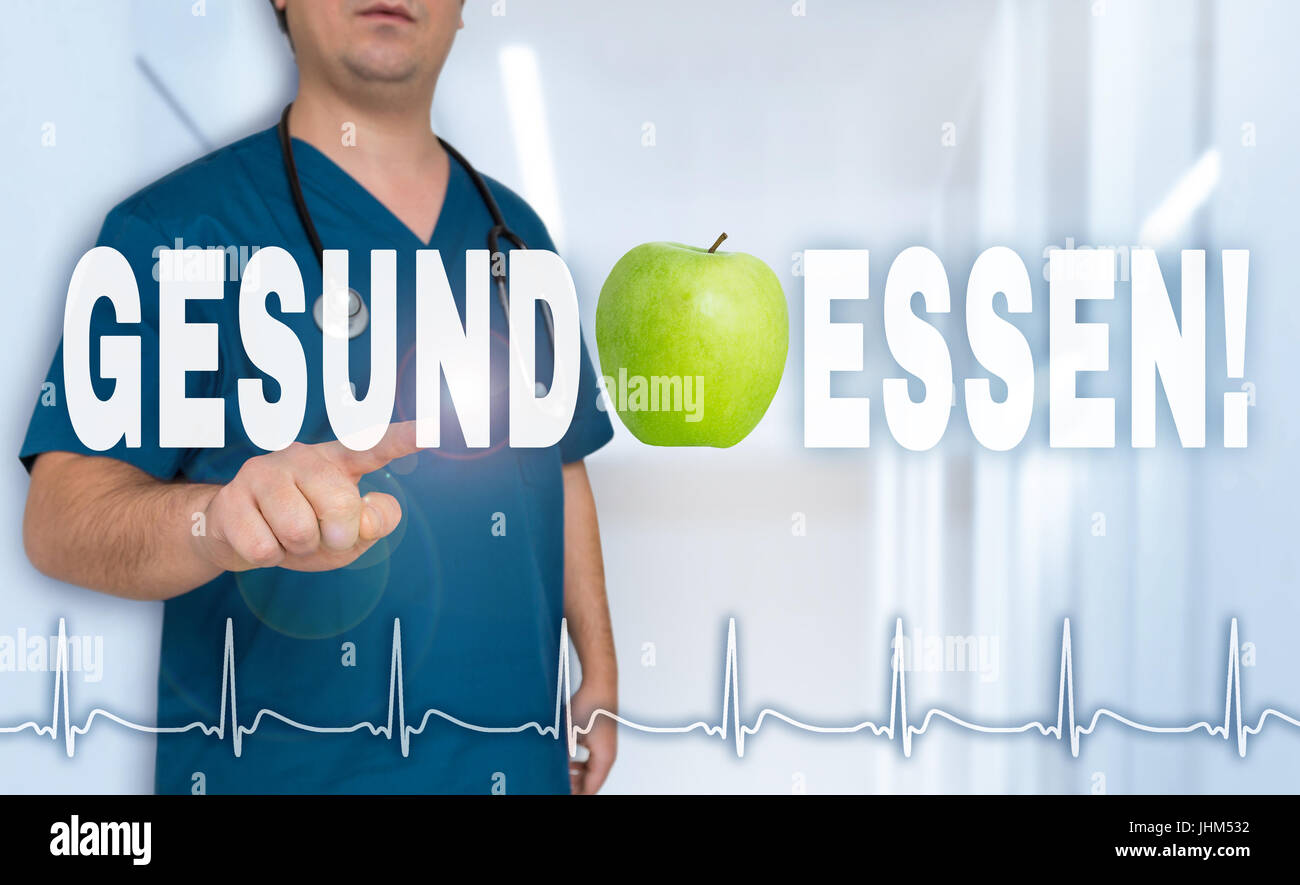 Gesund essen (in german Healthy eating) doctor shows on viewer with heart rate concept. Stock Photo