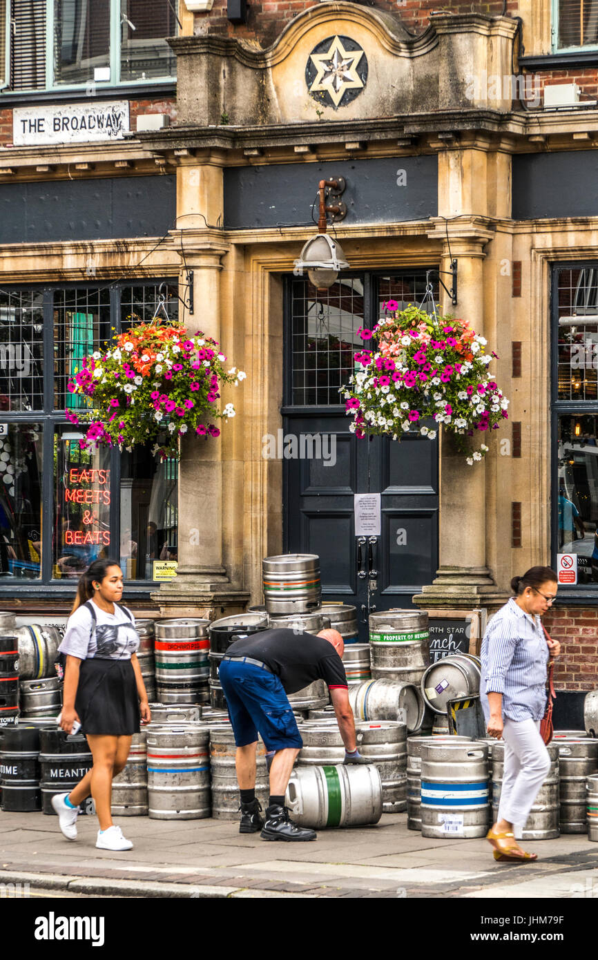 A brewery delivery driver, moving beer barrels outside a pub in Ealing