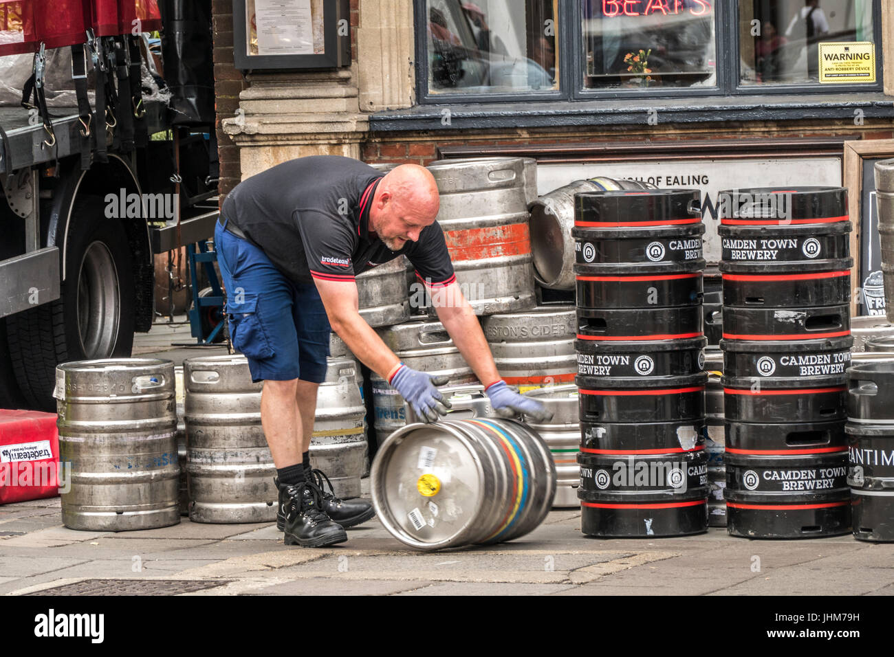 Rolling beer barrels outside a brewery hires stock photography and