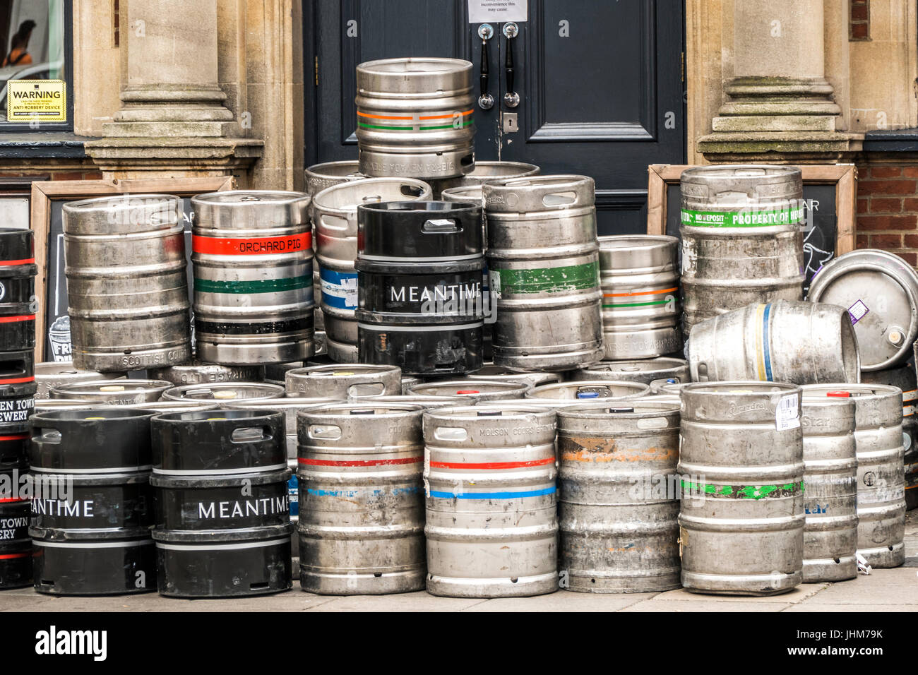 Beer barrels stacked up after delivery, outside a pub in Ealing Broadway, London W5, England, UK. Stock Photo