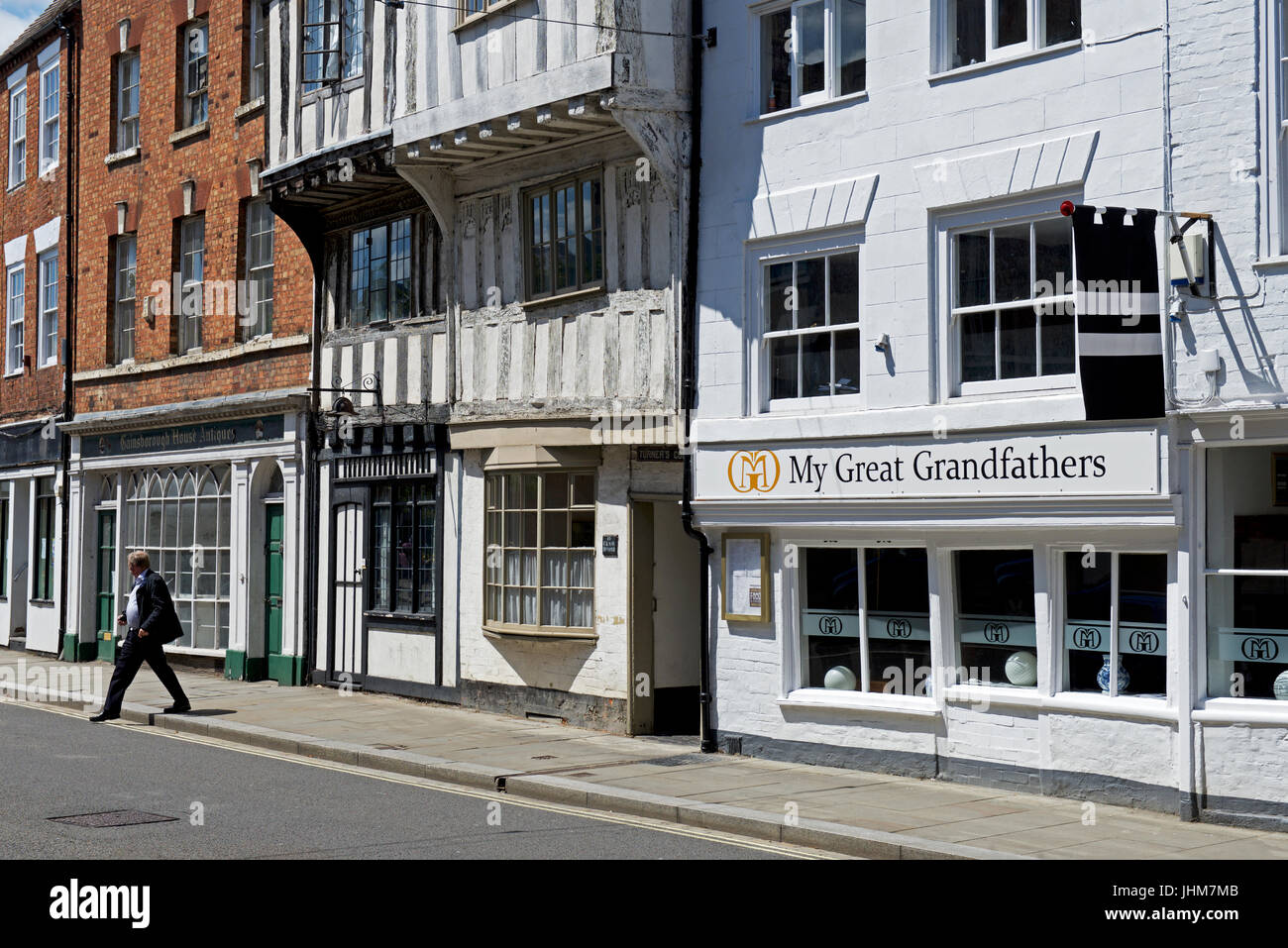 Man crossing road, Tewkesbury, Gloucestershire, England UK Stock Photo